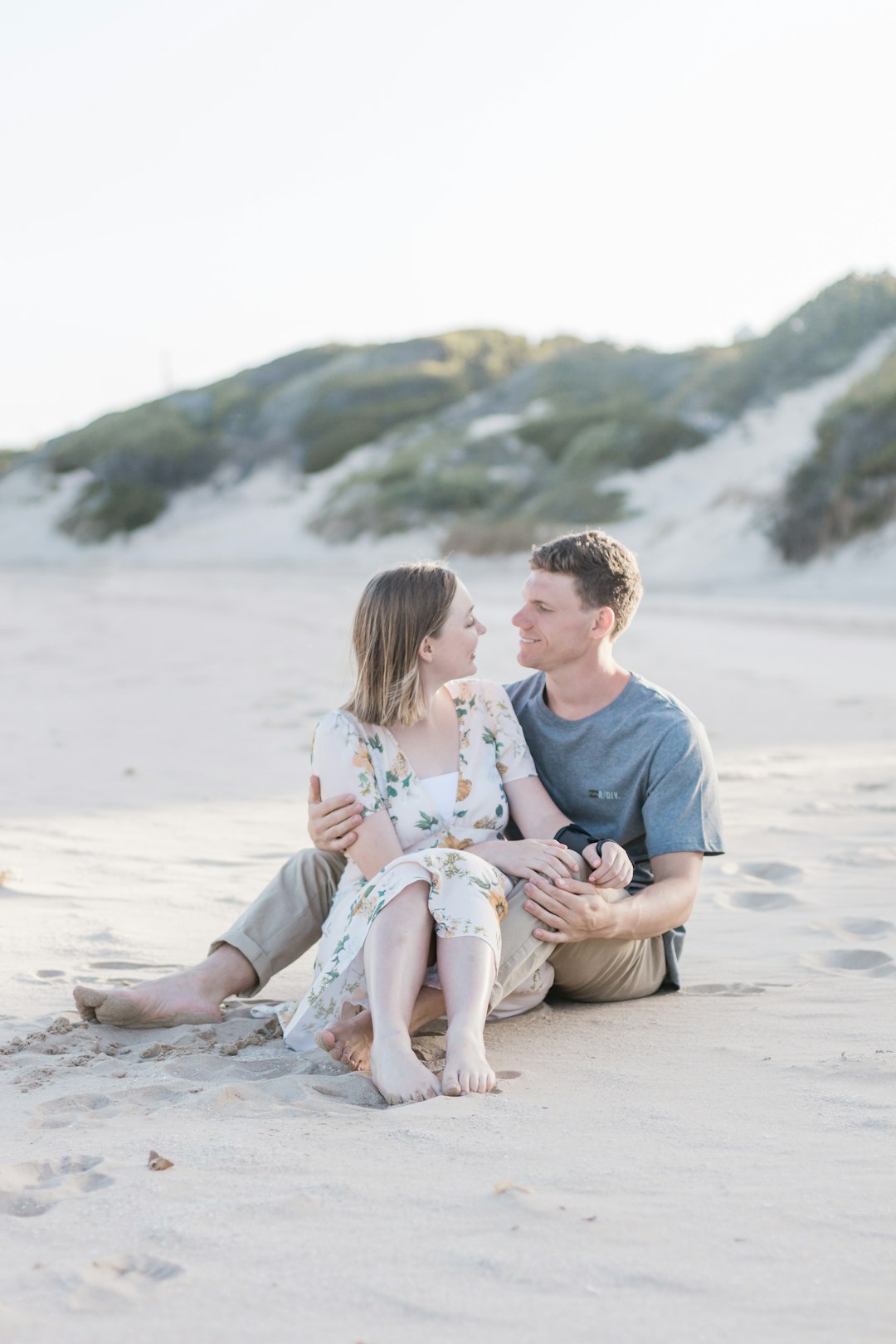 man and woman facing each other on shore at daytime