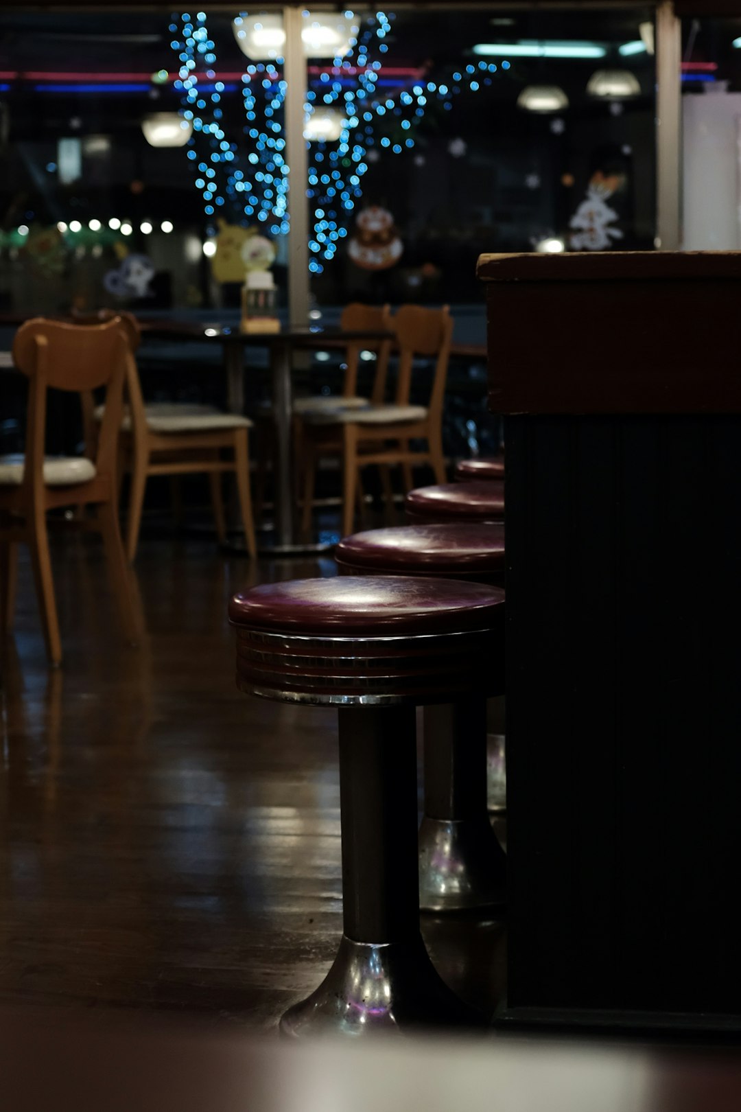 brown wooden bar stools infront of table