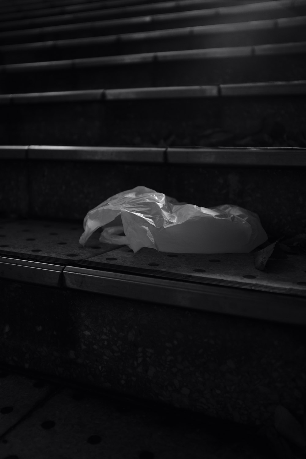 a plastic bag sitting on top of a bench