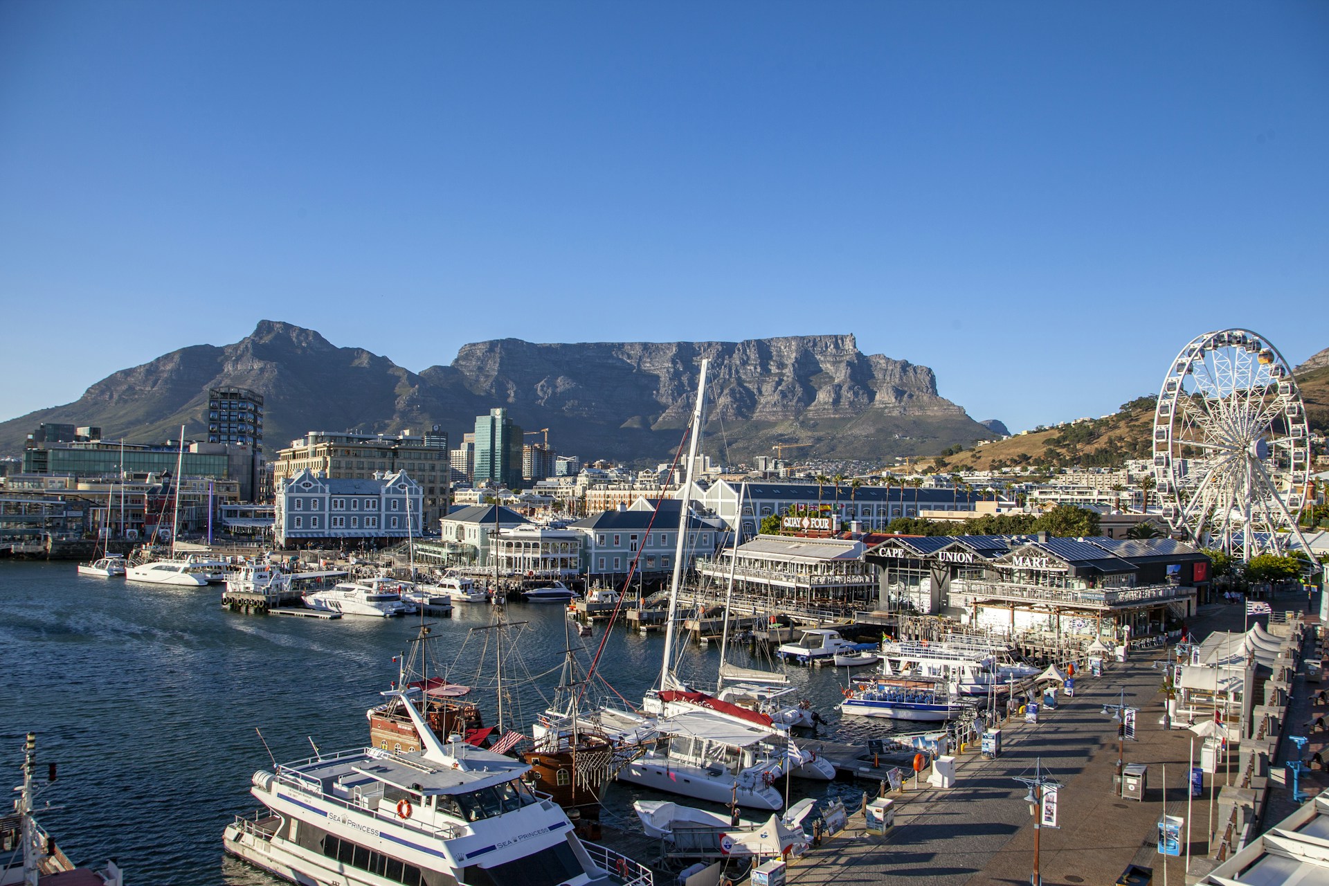 white motor boats parked near dock