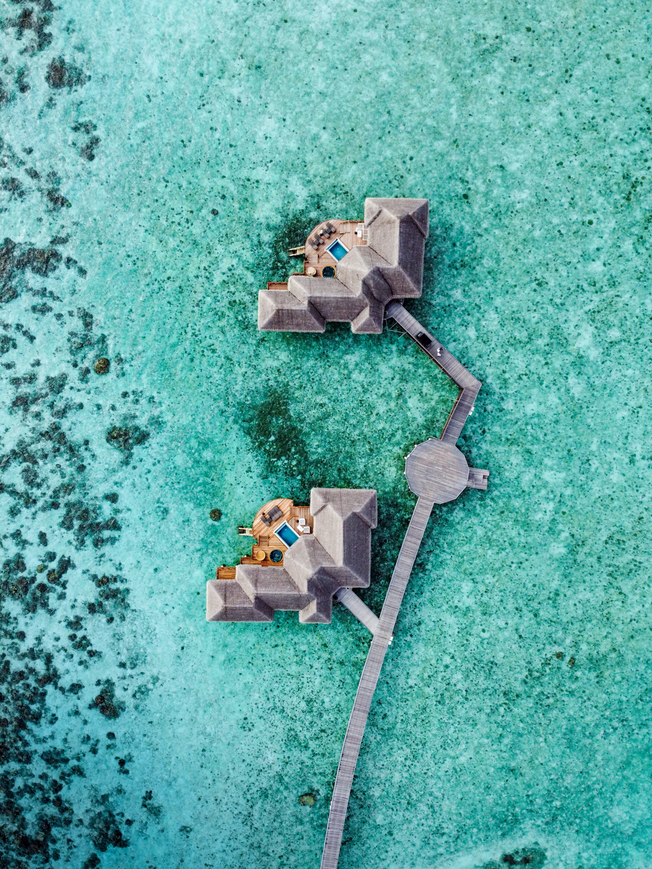 Overwater villas surrounded by a bright tropical lagoon