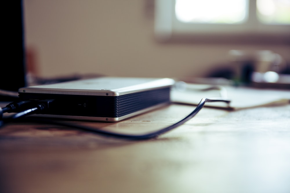 gray and black corded device on table