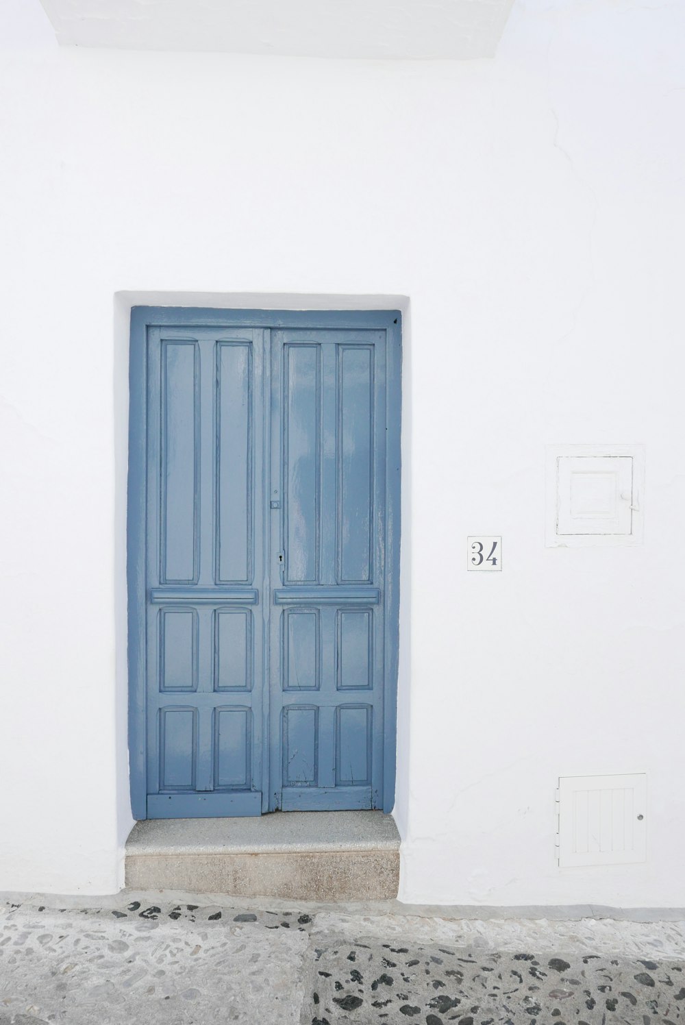 blue wooden 2-way door panel inside white room