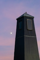 Detailed shot of the solar panel on top of a tall lighting tower against the night sky.