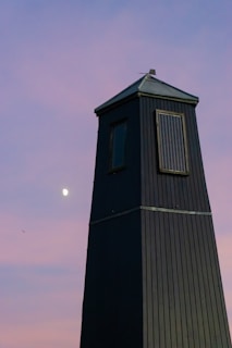 Detailed shot of the solar panel on top of a tall lighting tower against the night sky.
