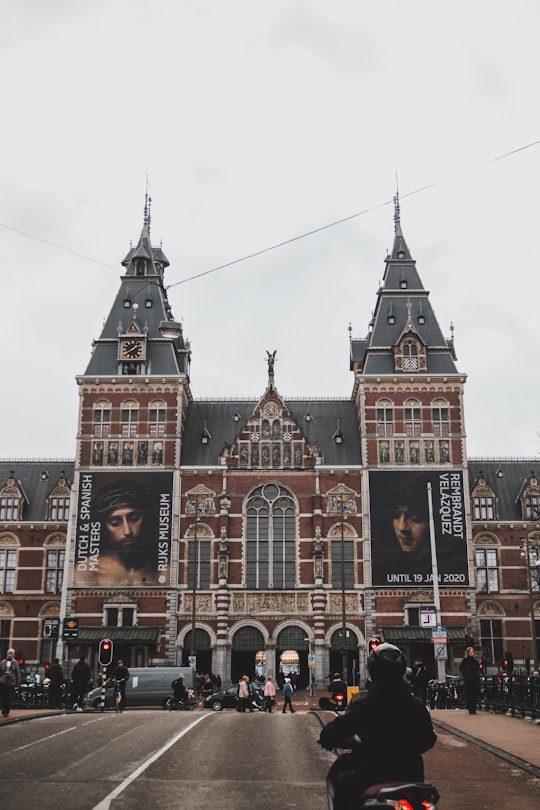 people in front of brown building during daytime in Rijksmuseum Netherlands