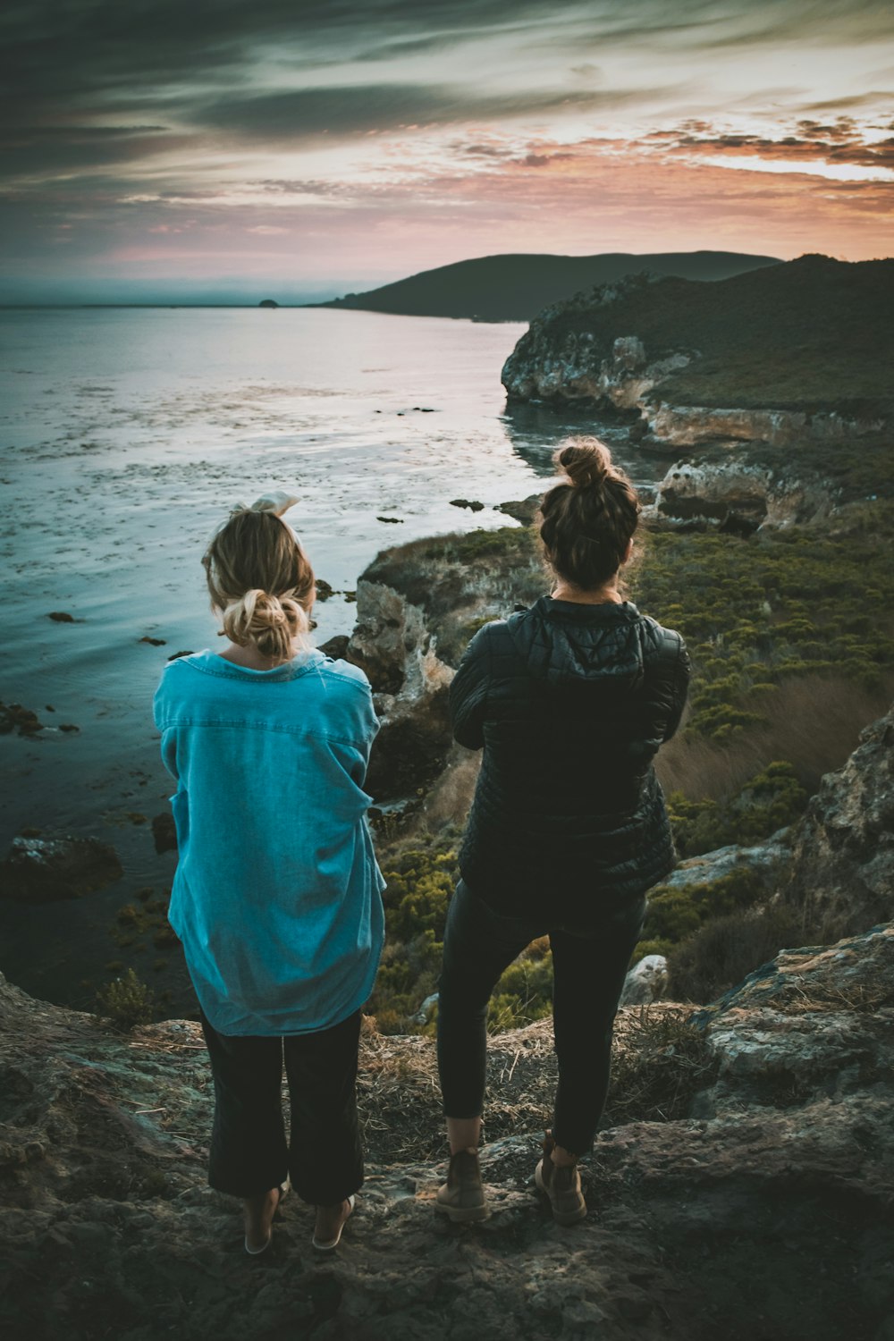 two person standing near body of water during daytime