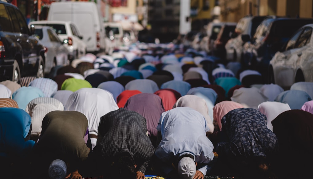 people kneeling and praying during daytime