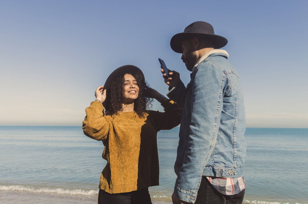 man and woman standing on seashore