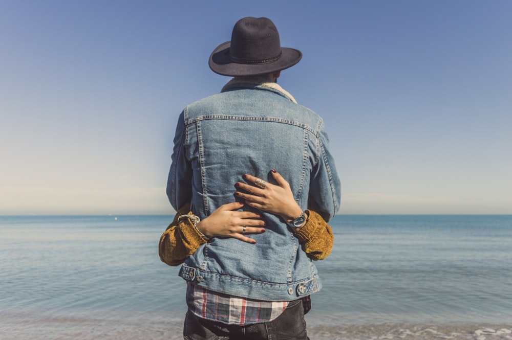 hugging man and woman on seashore