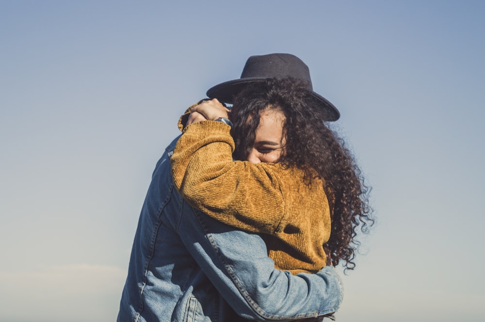 man and woman hugging during daytime