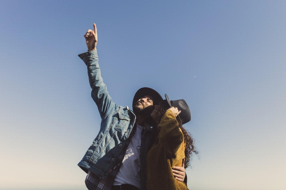 man and woman standing under blue sky