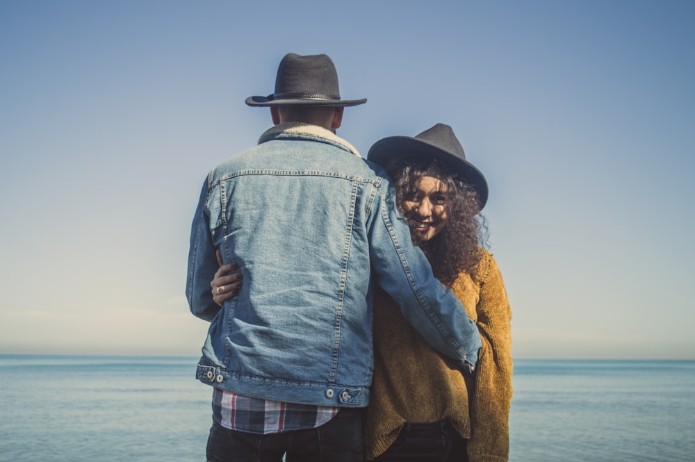 man and woman standing during daytime