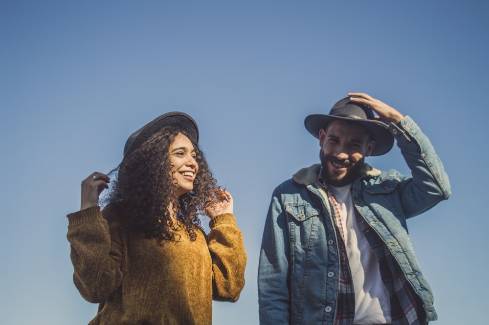 man and woman standing under blue sky