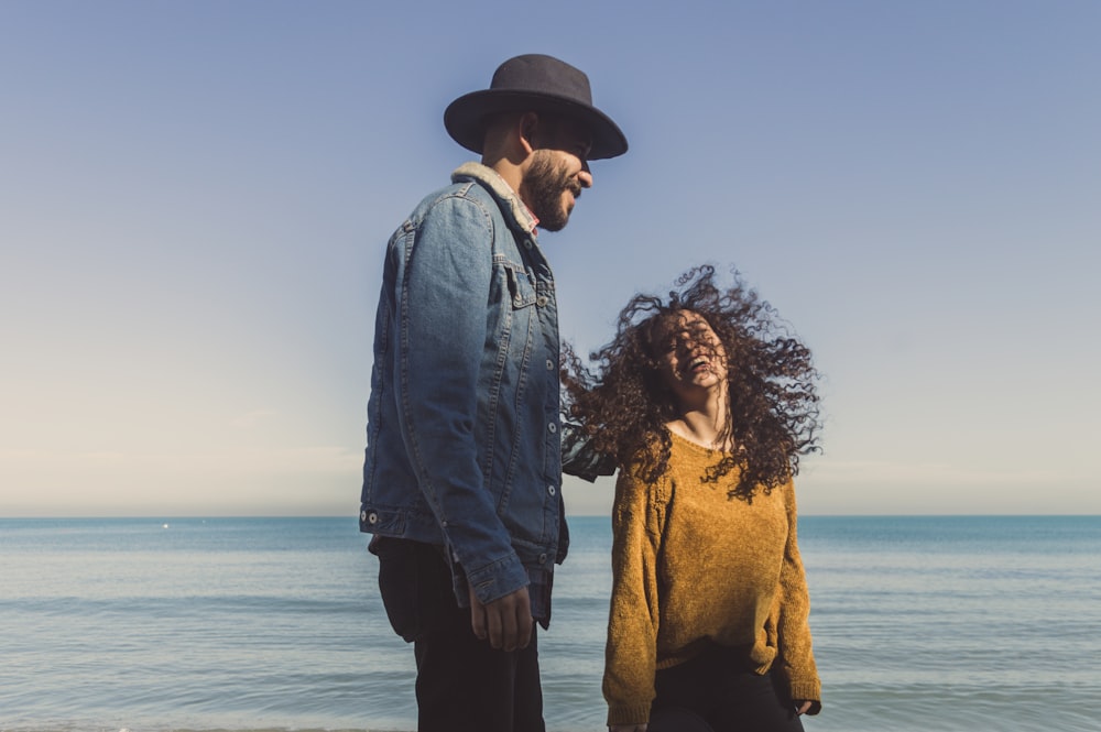 smiling man and woman on seashore