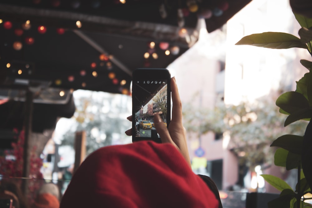 person holding turned-on black smartphone