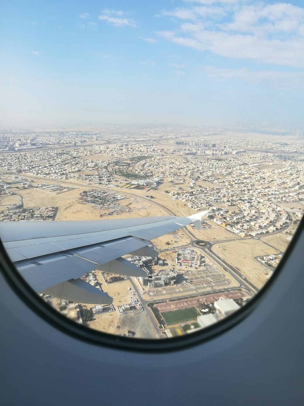 Airplane window view of houses photo – Free Dubai - united arab emirates  Image on Unsplash