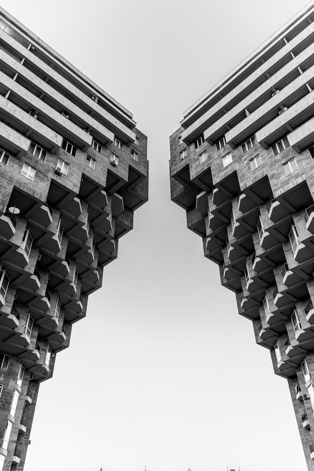 a black and white photo of two tall buildings