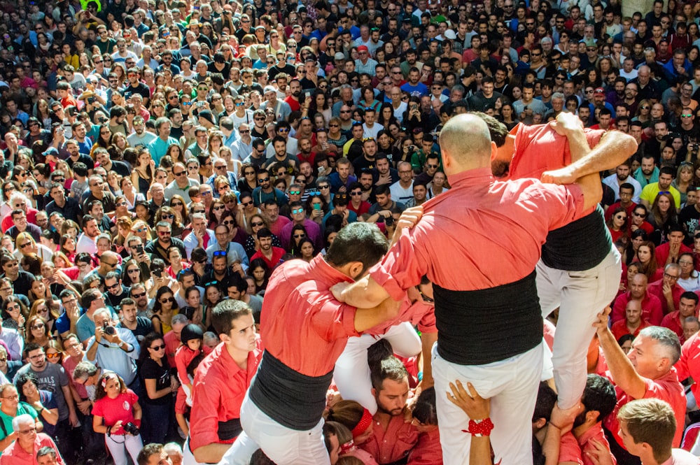 three men standing on crowd