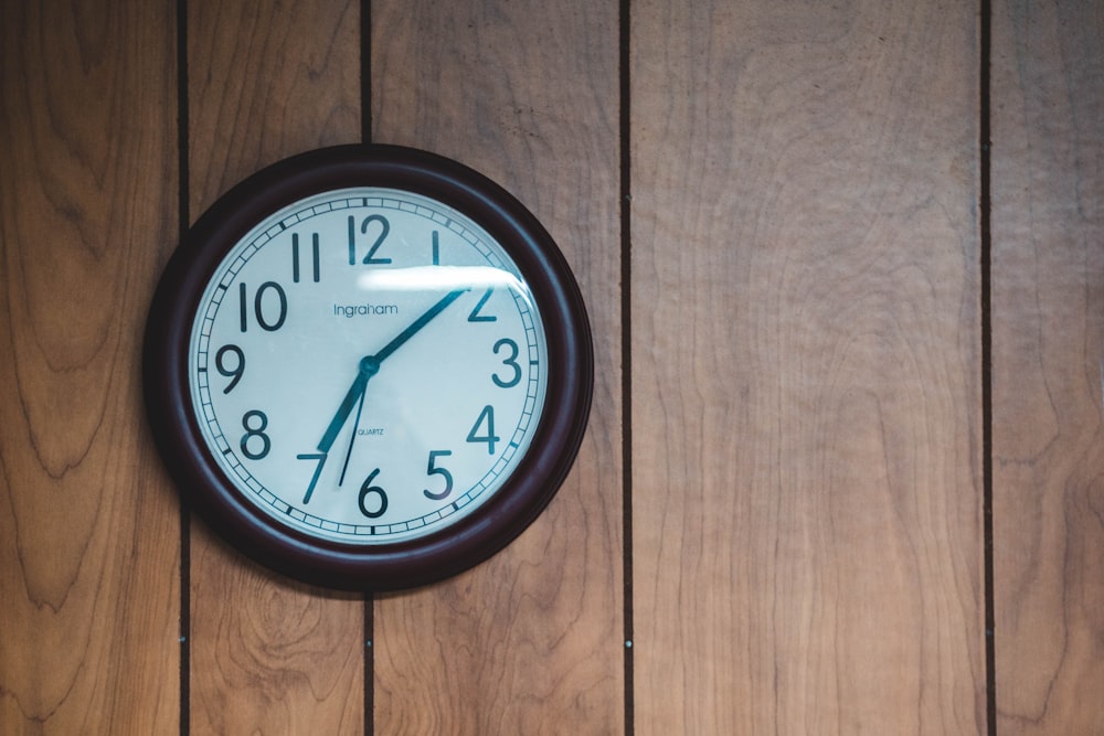 round white and black analog clock displaying 01:35 time