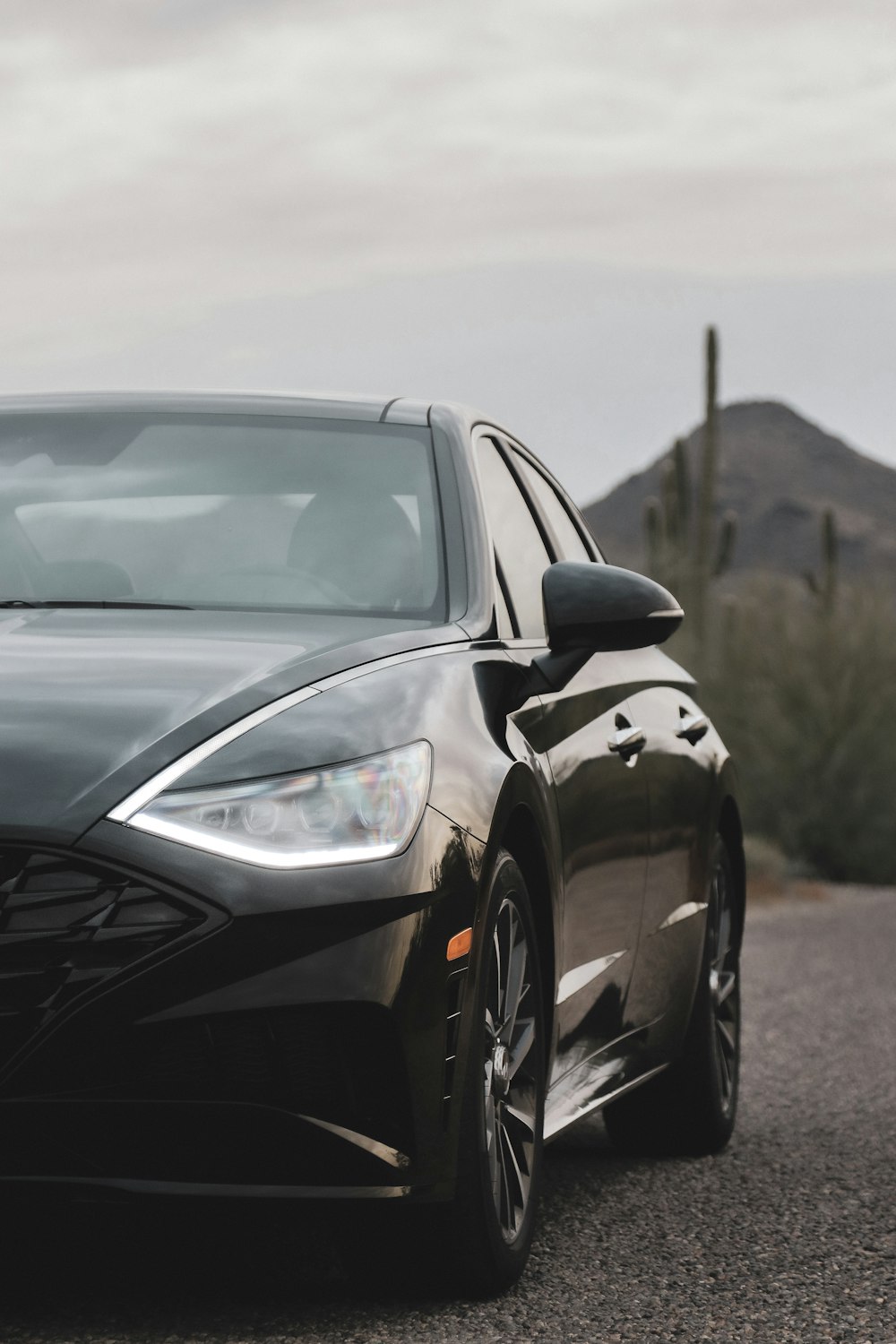 black sedan parking near road