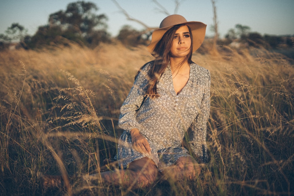 woman sitting on plant field