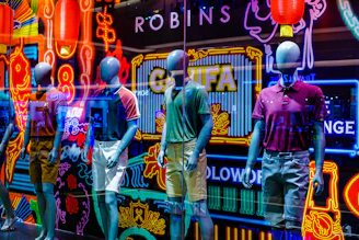 A vibrant display of casual wear on mannequins in a bright, modern studio setting.