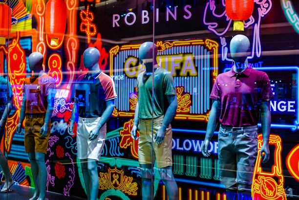 A vibrant display of casual wear on mannequins in a bright, modern studio setting.