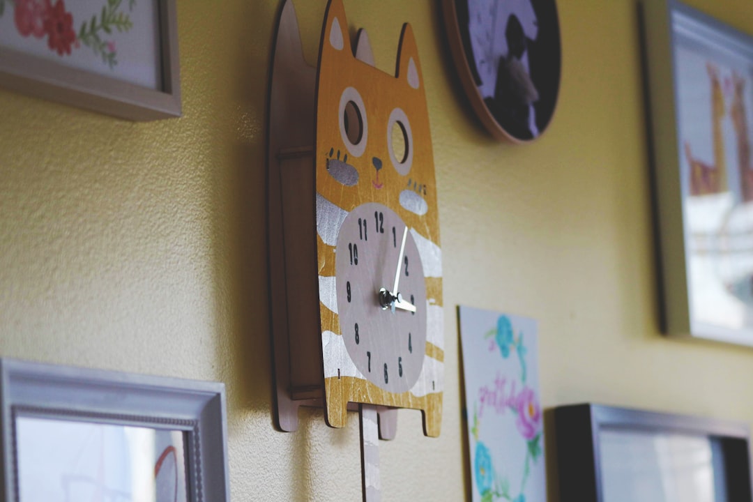 cat-themed analog wall clock displaying 3:05 time
