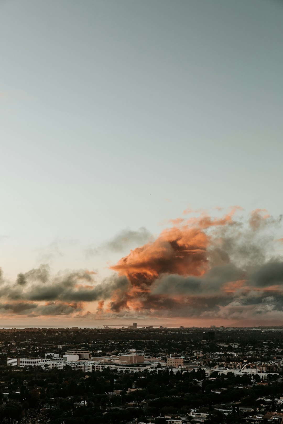 aerial photography of city with high-rise buildings under orange and gray sky