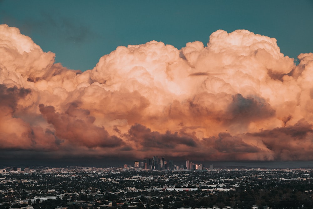 landscape photography of golden hour and white clouds over city