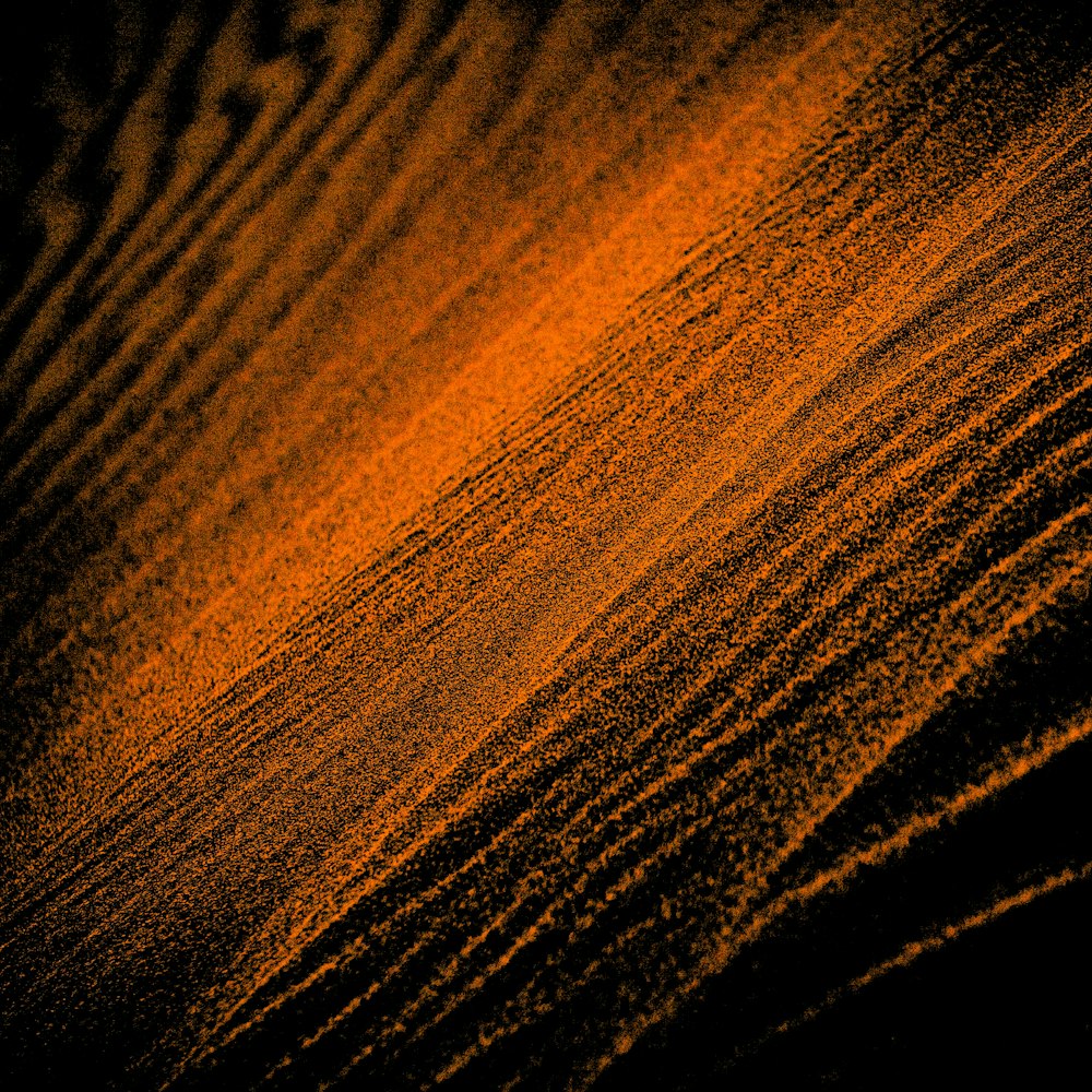 a close up of a wooden surface with a black background