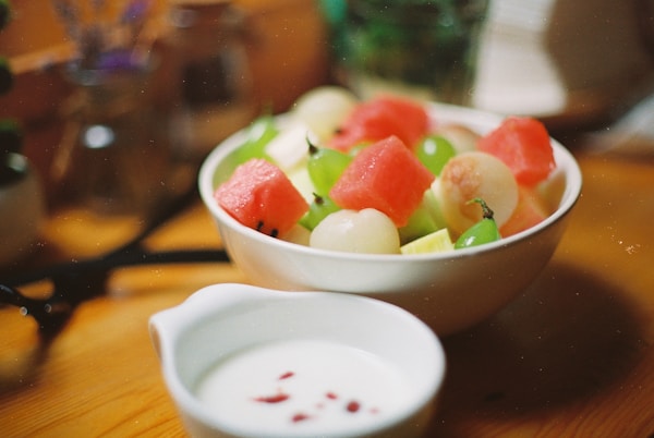 Macro photography of sliced watermelon, lychee, and green grapes fruit in round white bowl