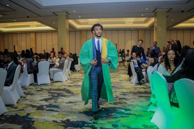 A formal gathering of masters and doctoral candidates in a bright conference hall.