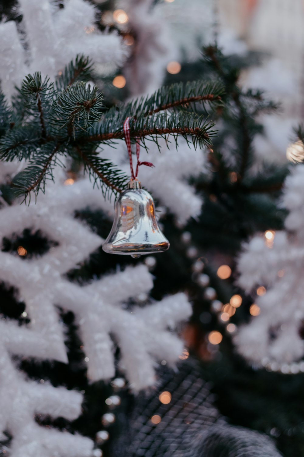 a christmas tree with a bell hanging from it