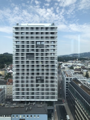 high-rise building near city under boue sky
