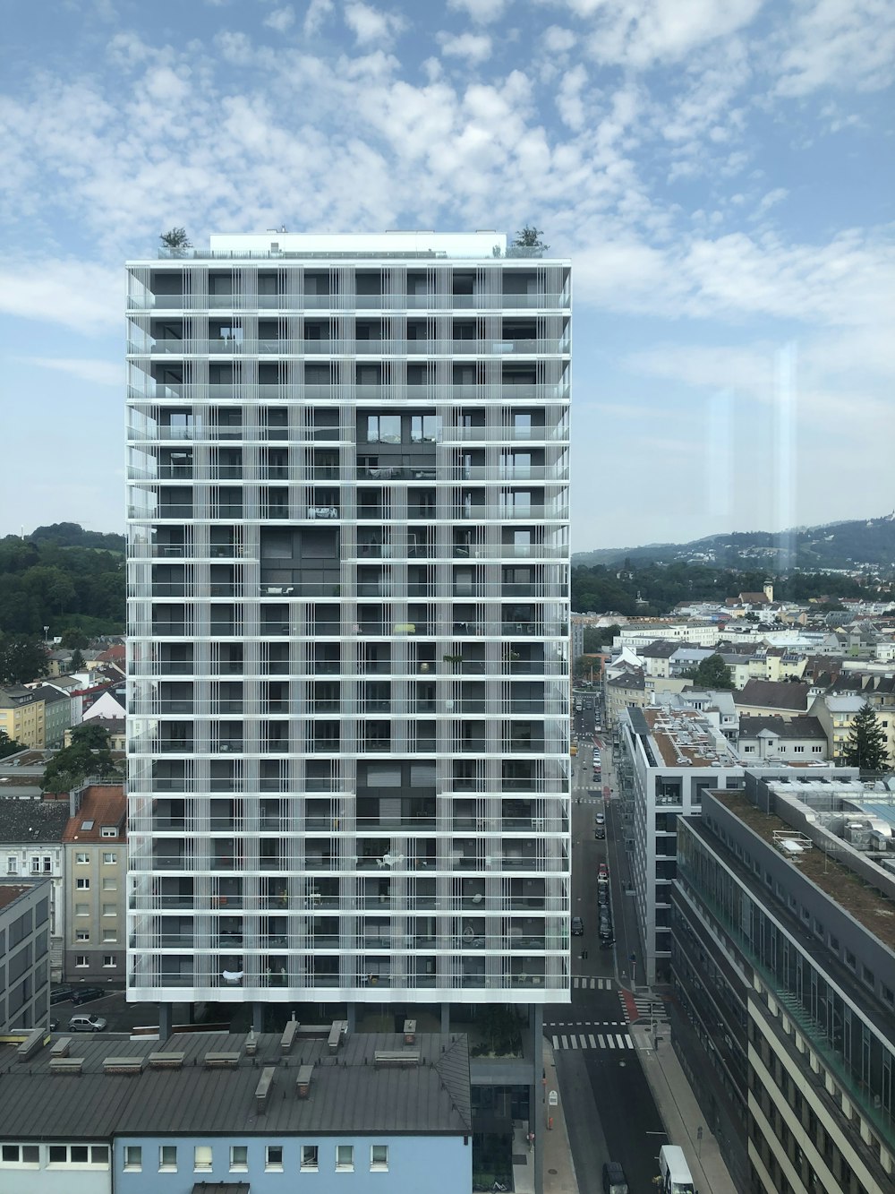 high-rise building near city under boue sky