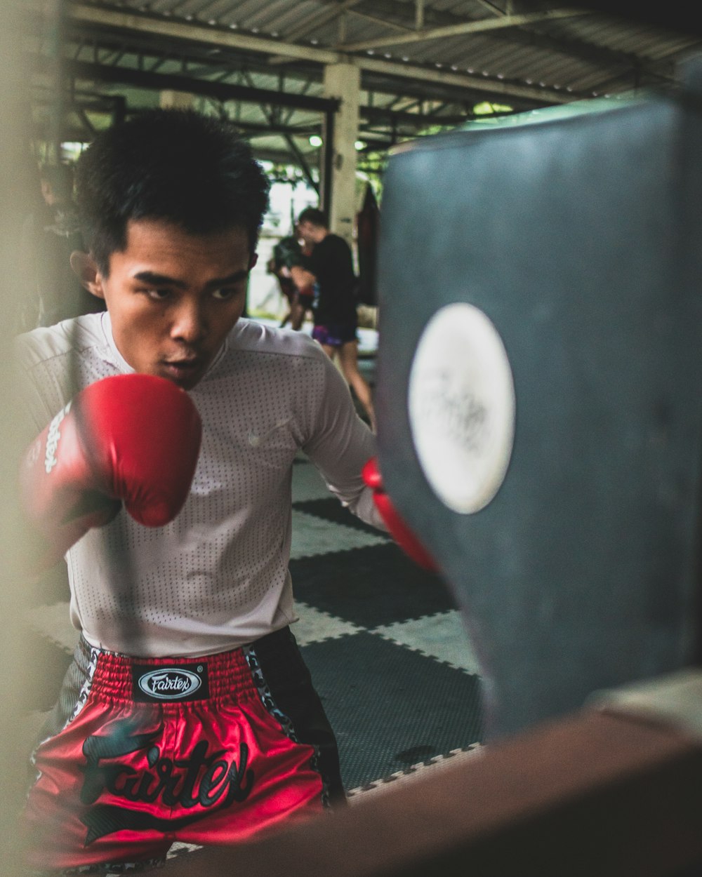 man punching heavy bag