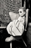 Stylish escort posing gracefully in a cozy lounge setting.