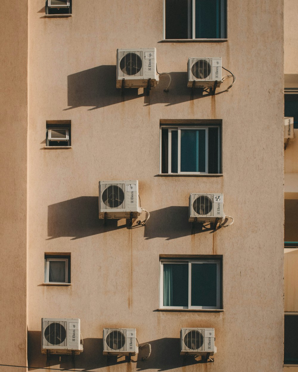 AC units mounted on wall outside building