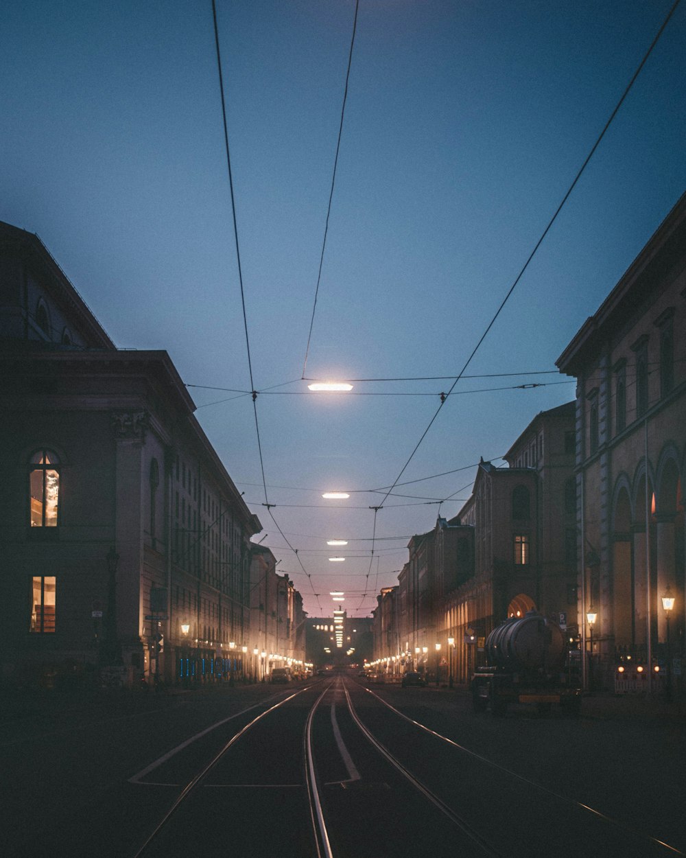 lighted tram rail between buildings