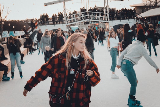 people skating on ice during day in Dam Square Netherlands
