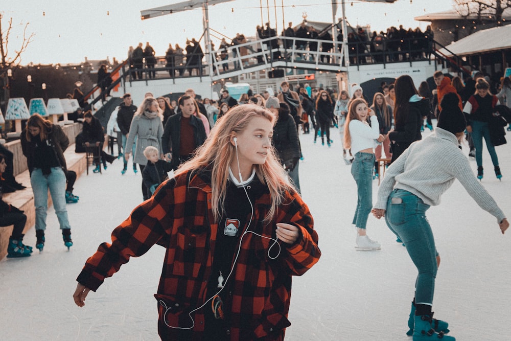 people skating on ice during day
