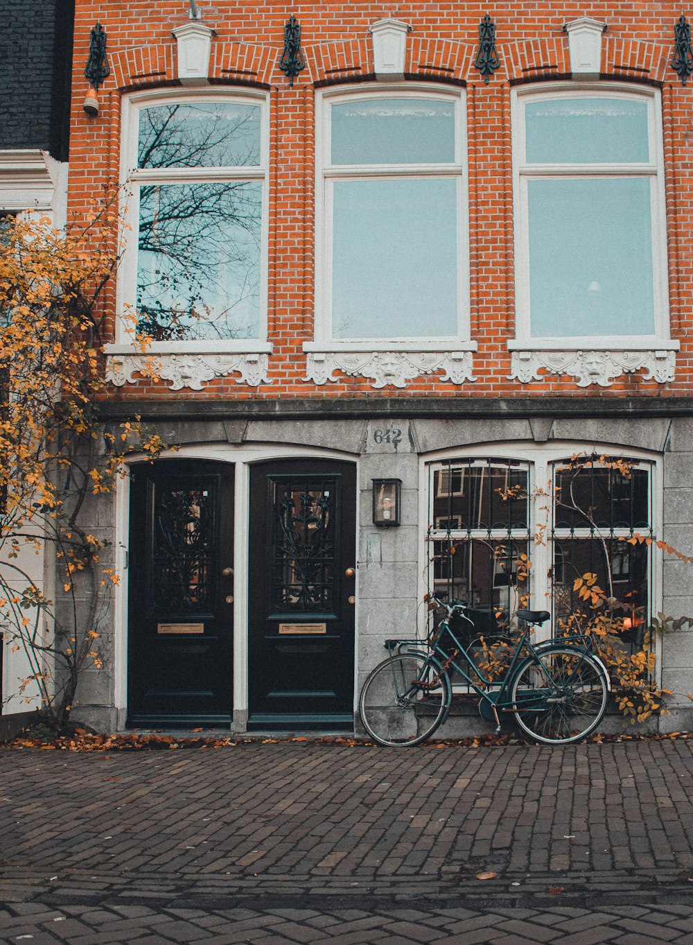 black bicycle parked on wall