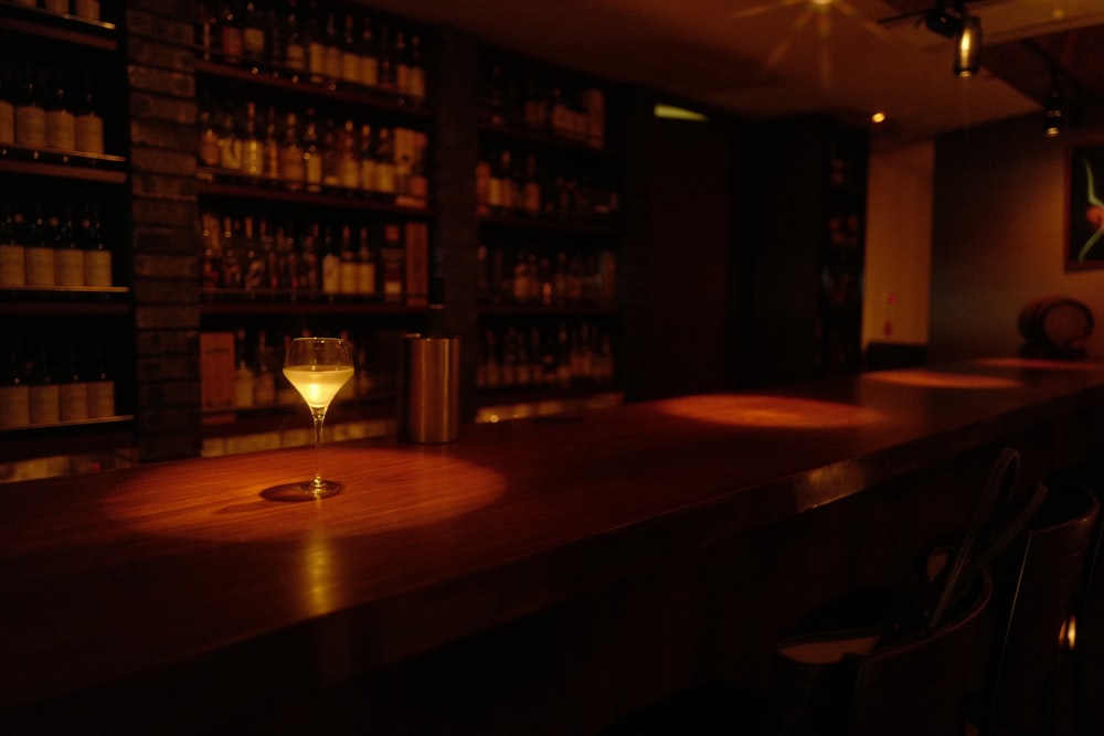 half-filled wine glass on bar kiosk