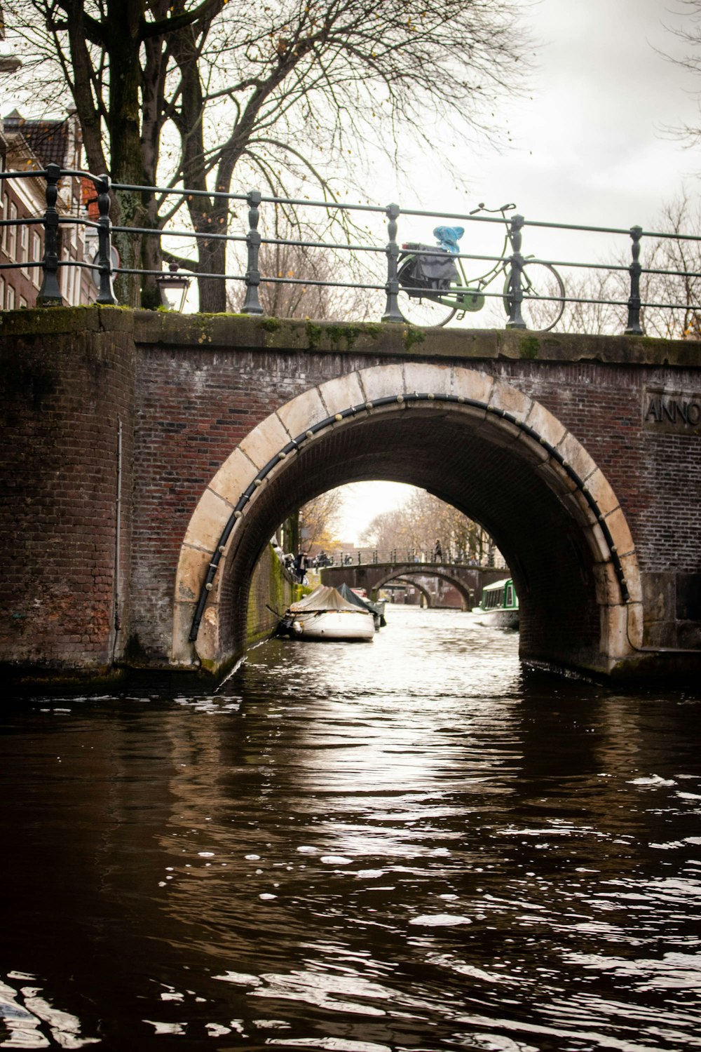 a bike is parked on a bridge over a canal