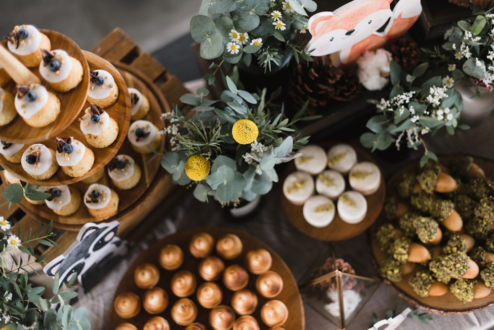 a table topped with lots of desserts and pastries