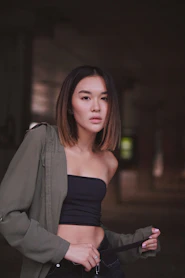 selective focus photography of woman wearing tube top and grey jacket