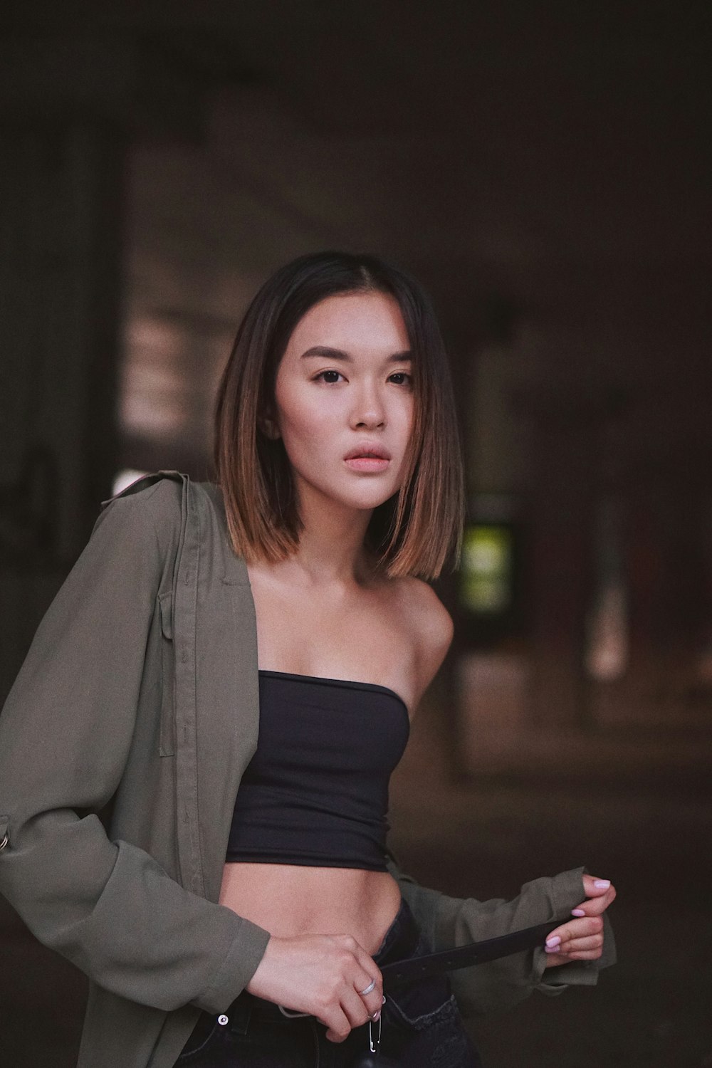 selective focus photography of woman wearing tube top and grey jacket