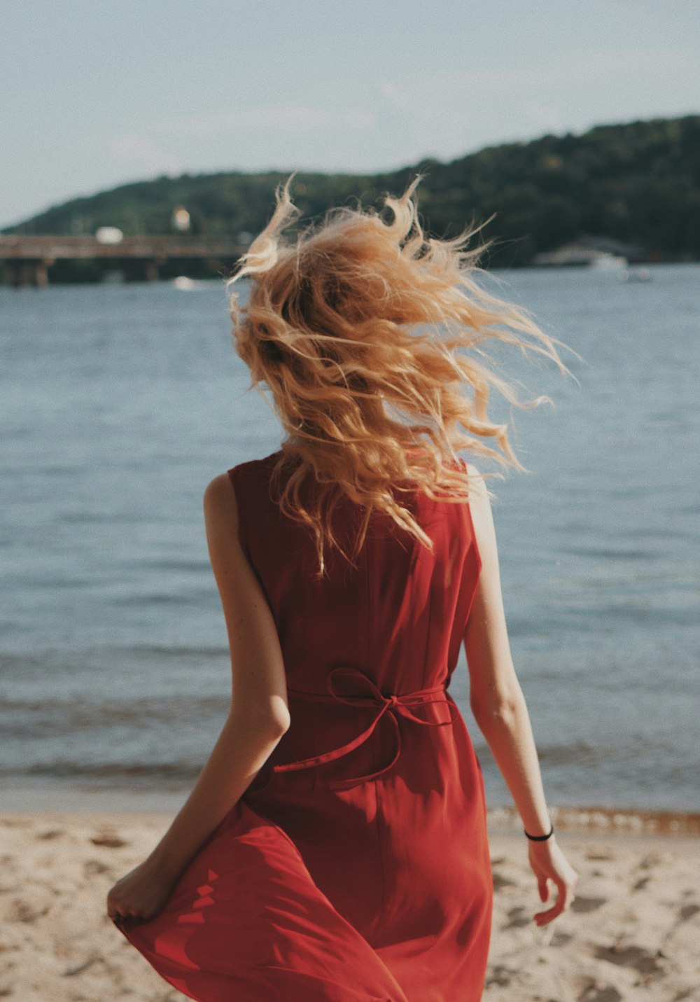 women's red sleeveless mini dress at shore